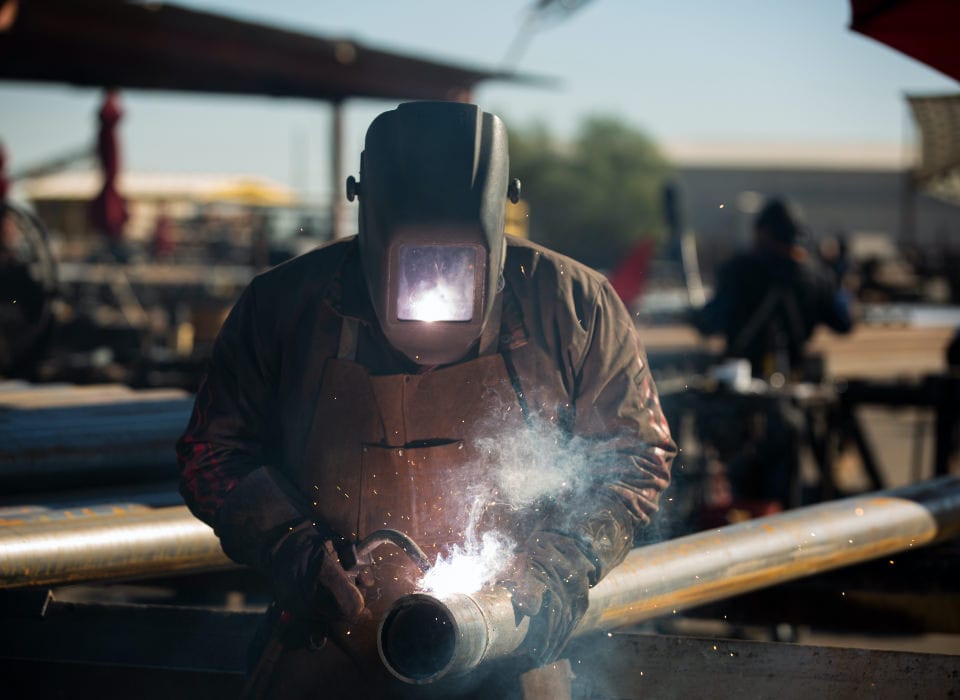 Man Soldering Steel Poles